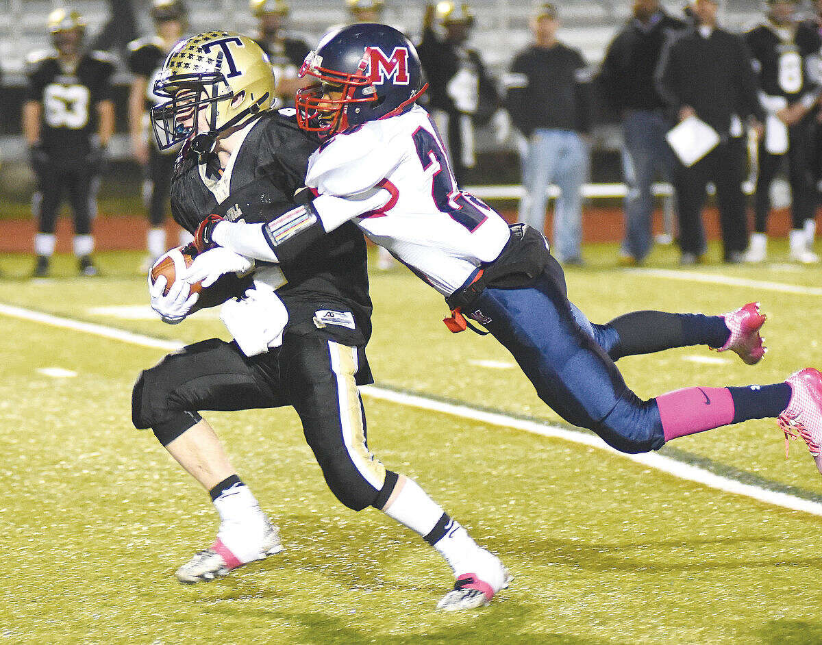 McMahon's Eric Day makes a tackle against Trumbull on Friday. (Hour photo/John Nash)