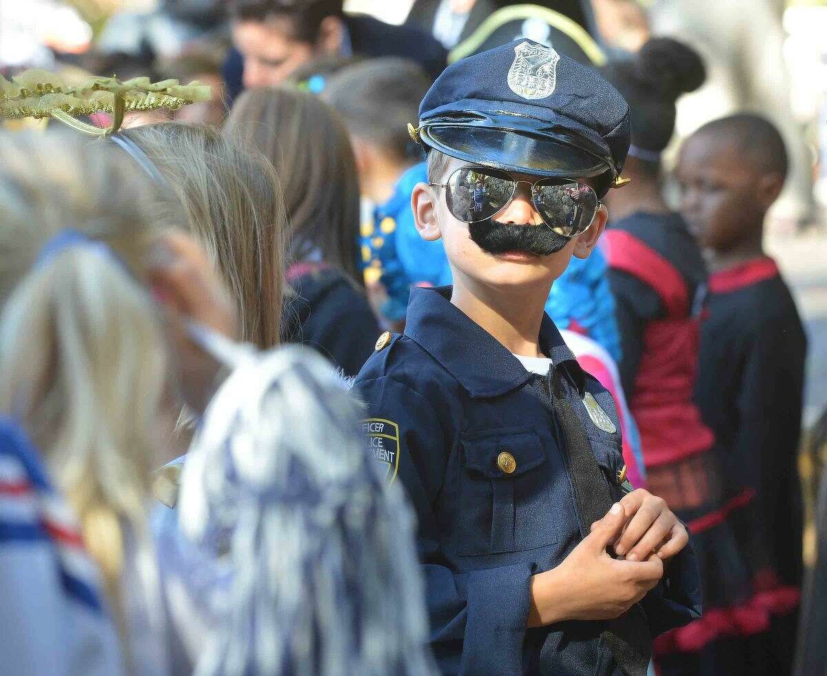 Hour Photo/Alex von Kleydorff 1st grader Sam Pavia grew his moustache upside down to make sure of the law and order during the Rowayton Elementary School's Halloween parade