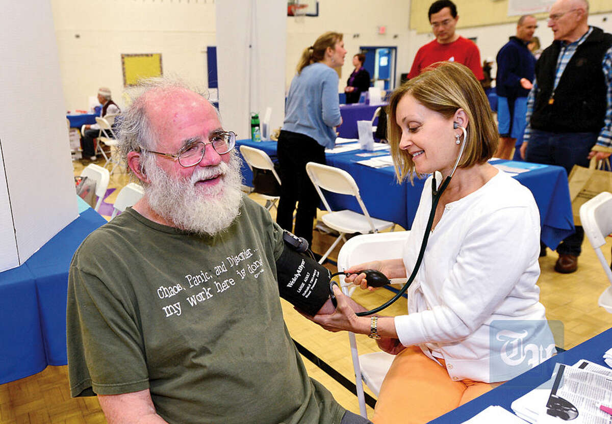 John Iles gets his blood pressure taken from Norwalk Hospital nurse practitioner Janet Kranes during The Hour Publishing Co. and Western Connecticut Health Network annual Health & Wellness Fair at Wilton Family Y Saturday.