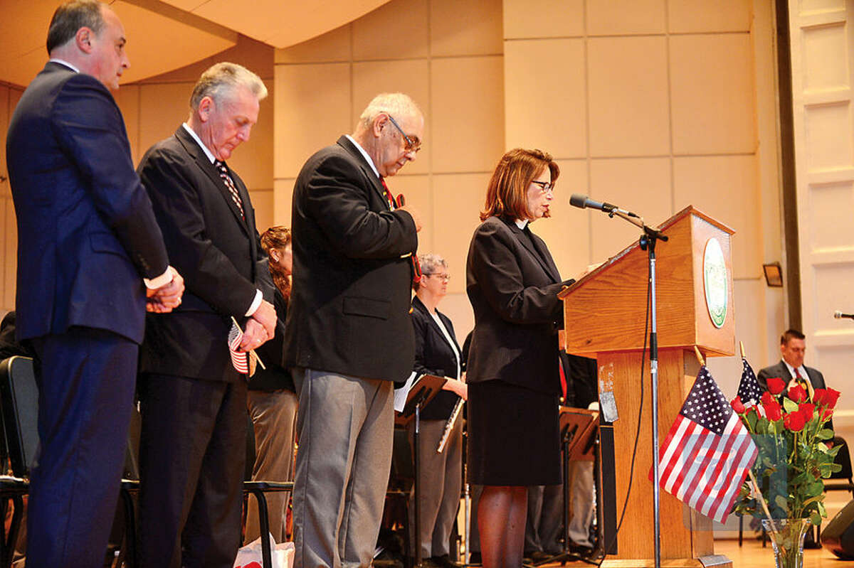 Hour photo / Erik Trautmann The Reverend Canon Patricia Coller of Christ Episcopal Church gives the Invocation as The Norwalk Veterans Memorial Committee holds their 2015 Veterans Day Ceremony Wednesday at the Norwalk Concert Hall.