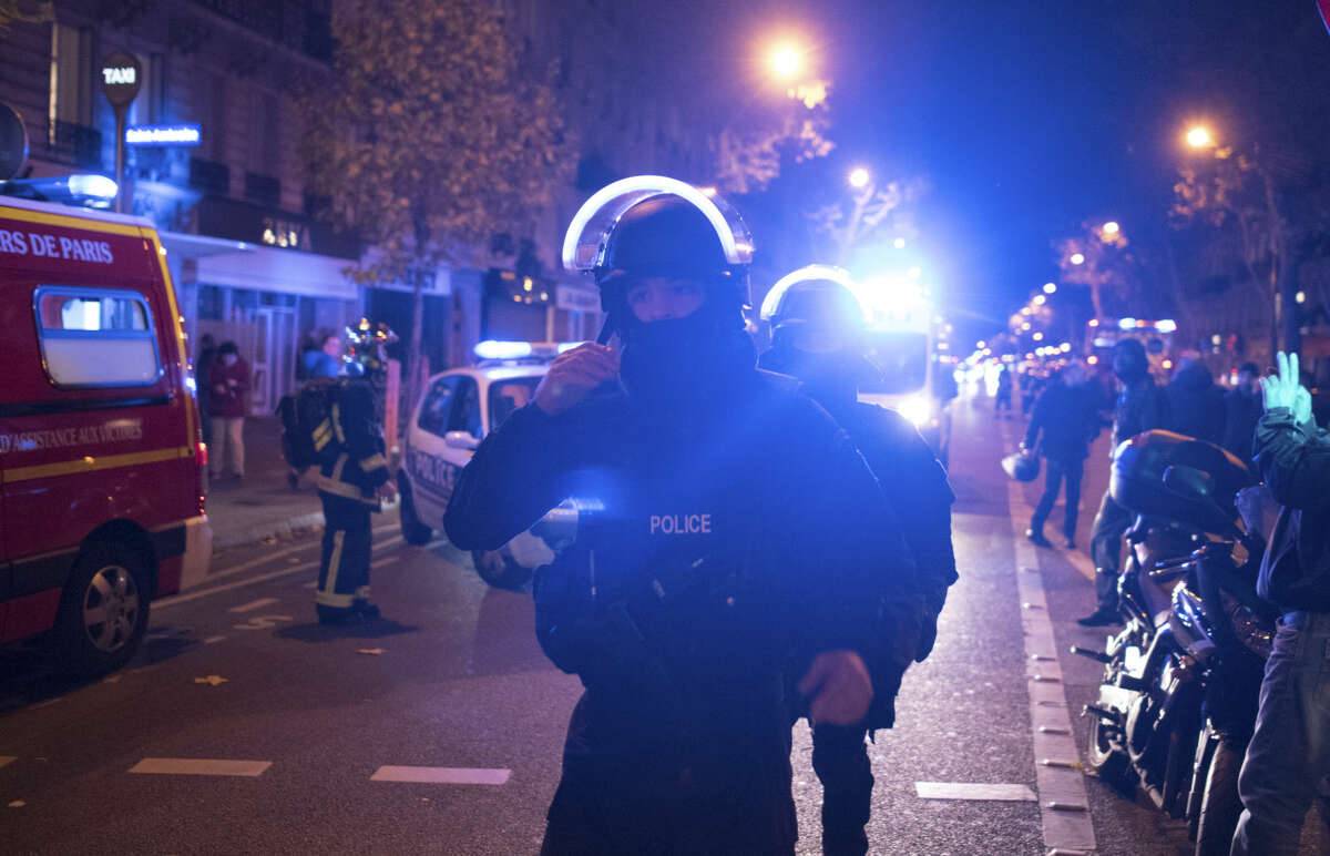 Elite police officers arrive outside the Bataclan theater in Paris, France, Wednesday, Nov. 13, 2015. Several dozen people were killed in a series of unprecedented attacks around Paris on Friday, French President Francois Hollande said, announcing that he was closing the country's borders and declaring a state of emergency. (AP Photo/Kamil Zihnioglu)