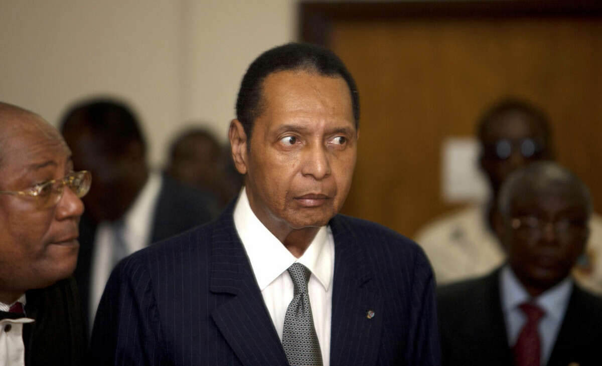 FILE - In this file photo dated Feb. 28, 2013, former Haitian dictator Jean-Claude Duvalier, known as "Baby Doc," attends his hearing at court in Port-au-Prince, Haiti, as Haitian authorities charged Duvalier with human rights abuses and embezzlement but a judge ruled he should face charges only for the alleged financial crimes. It is announced Saturday Oct. 4, 2014, that Haitian ex-dictator Jean-Claude Duvalier has died of a heart attack. (AP Photo/Dieu Nalio Chery, FILE)