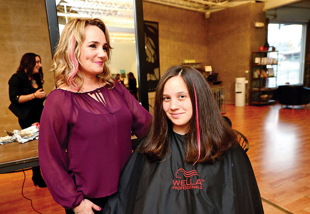 Hour photo / Erik Trautmann SoNo Academy owner Thea Tsiranides is promoting pink hair extensions for customers like Sarah Laguardia to show support for Breast Cancer Awareness Month and donating a portion of its proceeds to Smillow Family Breast Health Center of Norwalk Hospital.