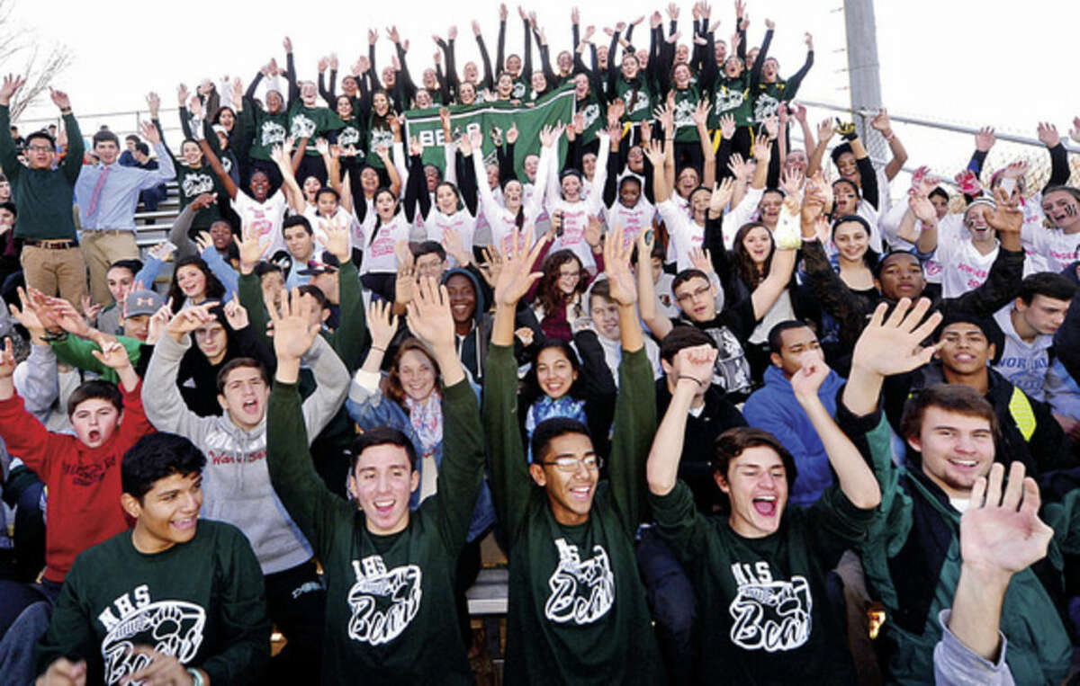 Hour photo / Erik Trautmann Norwalk High School sports fans, affectionately known as the Bear Pack, cheer at the Powder Puff football game Friday.