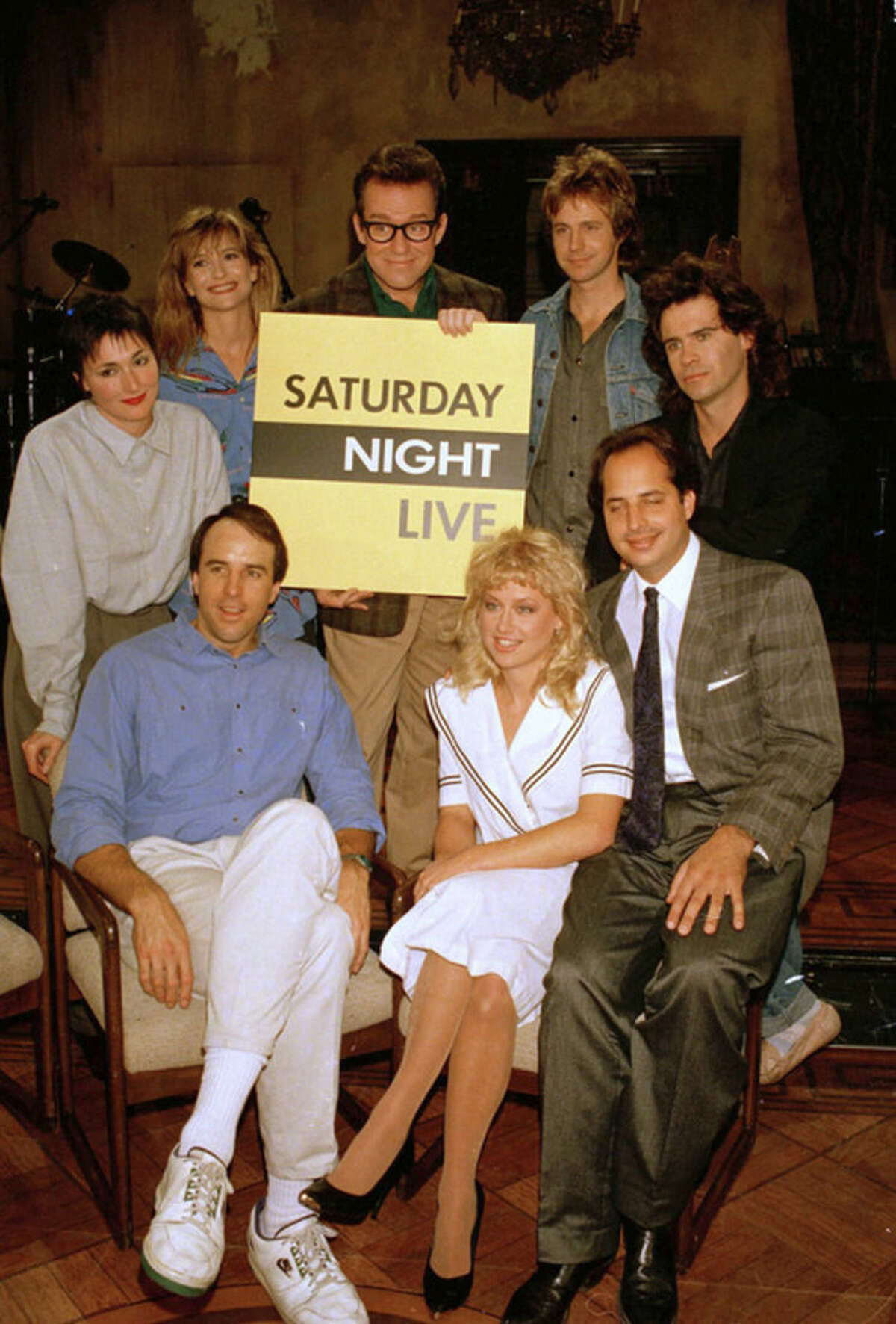 FILE - In this Dec. 9, 1986 file photo, the cast of NBC's "Saturday Night Live," clockwise, from left, Nora Dunn, Jan Hooks, Phil Hartman, Dana Carvey, Dennis Miller, Jon Lovitz, Victoria Jackson, and Kevin Nealon, pose together, in New York. Hooks, the former "Saturday Night Live" cast member has died. She was 57. Hooks died Thursday, Oct. 9, 2014 according to her agent Lisa Lieberman. (AP Photo/Richard Drew, file)