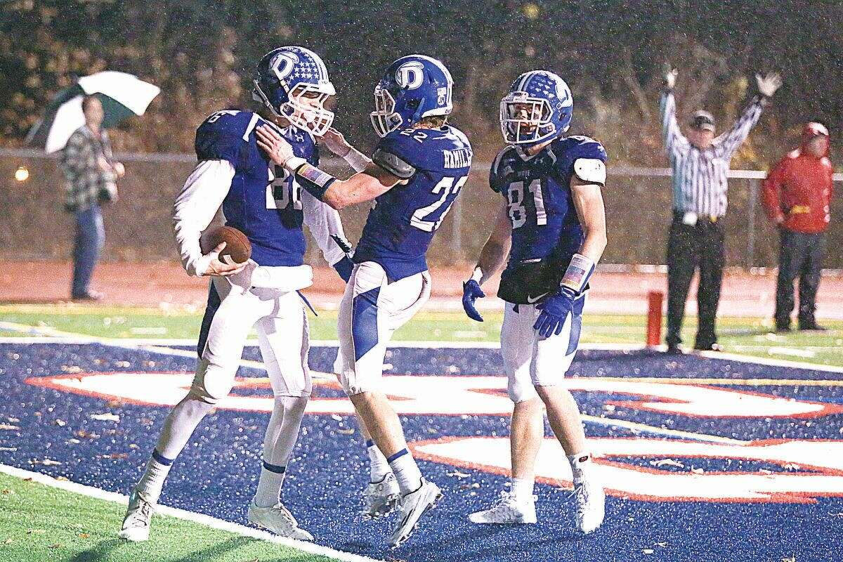 Hour photo/Chris Palermo. Darien players celebrate Spencer Jarecke's touchdown during Darien's 41-7 Class LL state tournament victory over Staples at Brien McMahon High School Tuesday night.
