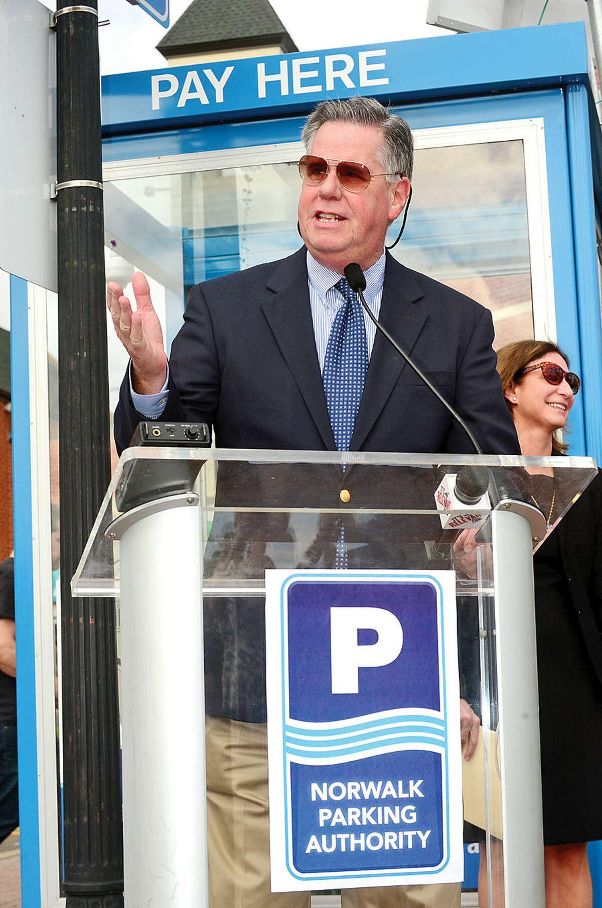 Hour photo / Erik Trautmann Greater Norwalk Chamber of Commerce president Ed Musante speaks during a press conference at the North Water St lot Tuesday as the Norwalk Parking Authority announces a new digital initiative that allows access to parking availability information with the smart phone application, Parker. The system works via wireless sensors that are embedded in parking space to detect whether or not the space is occupied. Data from each sensor is relayed via wireless to the cloud and pushed into an easy-to-use app showing real-time parking availability. CASE parking, a parking data solutions provider, will collect occupancy data from the lots and garages. Streetline, the leading global provider of sensor-based smart parking technology, has outfitted the on-street parking spaces with sensors. The data from both systems will be streamed directly into Streetline's mobile app, Parker.