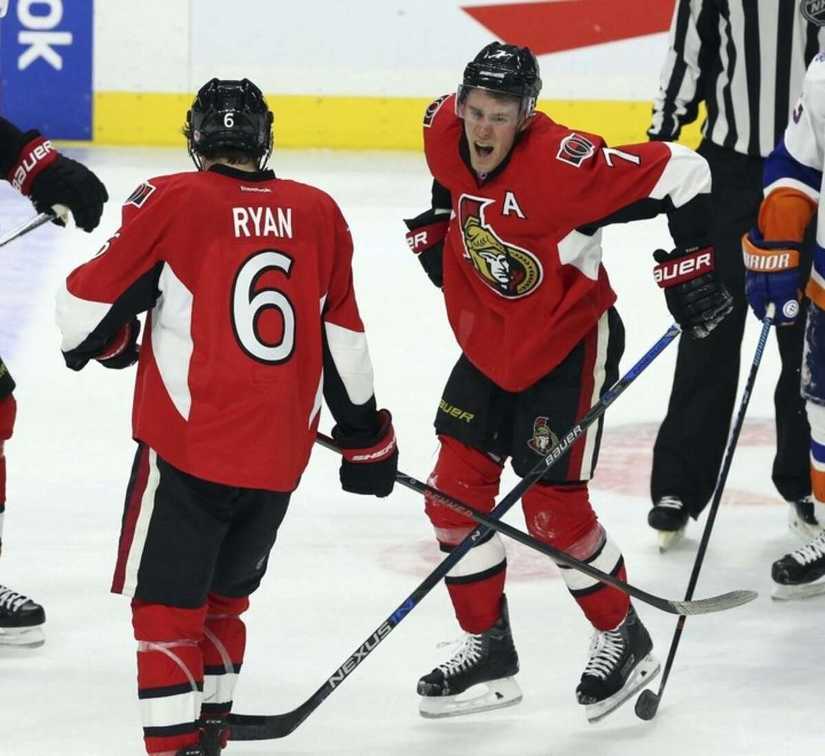 Ottawa Senators' Kyle Turris (7) reacts after being injured during third period NHL action against the New York Islanders in Ottawa, Saturday, Dec. 5, 2015. (Fred Chartrand/The Canadian Press via AP)