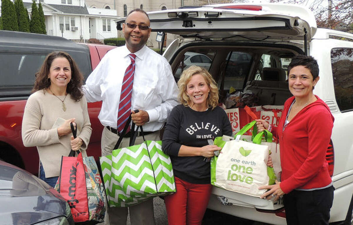 Liberation Programs’ President and CEO, Alan Mathis, helps Darien friends unload one of 8 SUVs filled with bags heavy with food and toiletries. Michelle Luttrell (second from right) called upon some of her closest friends to help bring “100 bags of HOPE” to women in Bridgeport who receive professional counseling and addiction services at Liberation’s Outpatient Clinic in Bridgeport.(left to right): Heidi Daileader, Alan Mathis, Michelle Luttrell and Chris Ludlow.