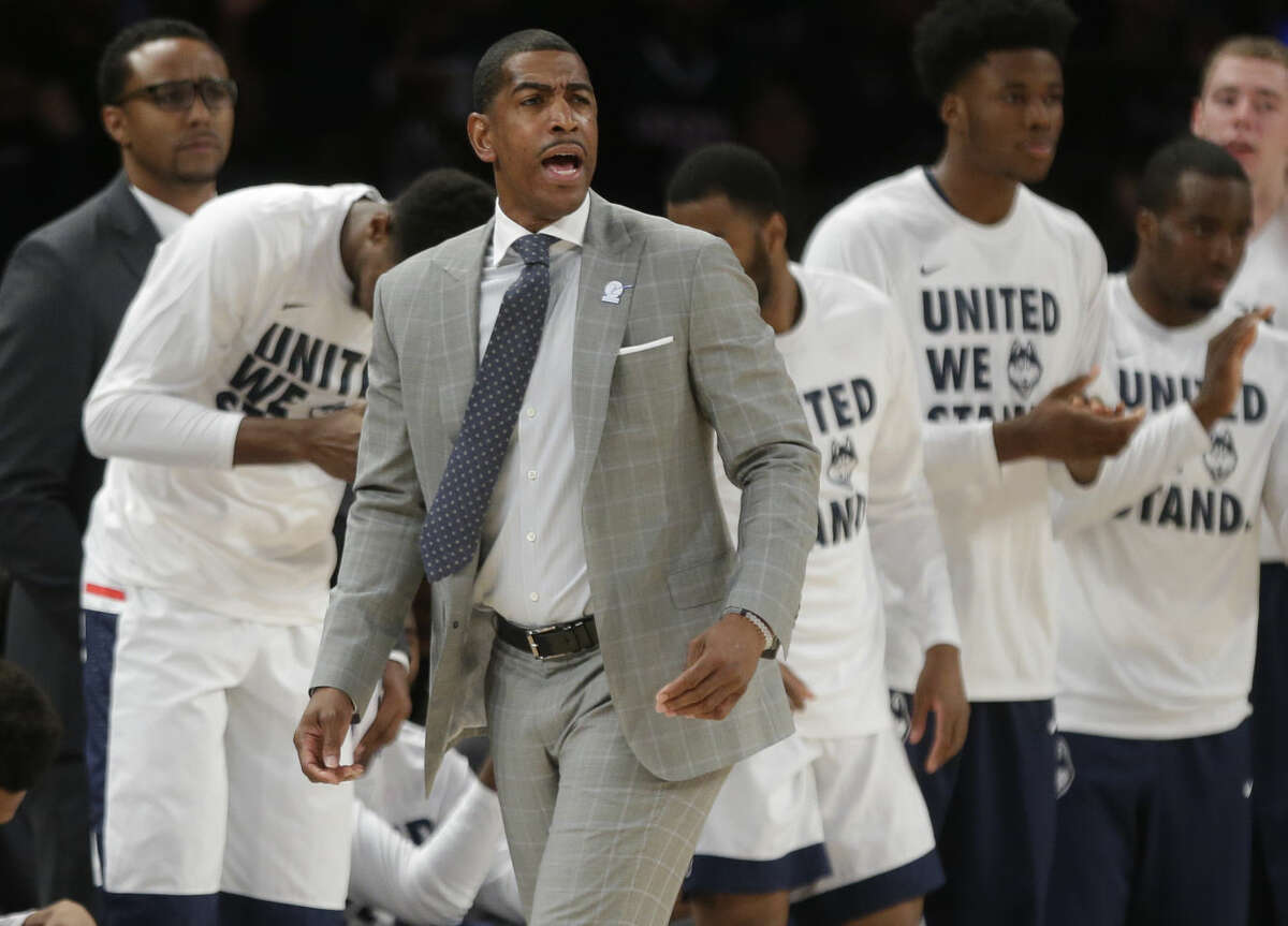 Connecticut head coach Kevin Ollie calls out to his team during the first half of an NCAA college basketball game against Maryland, Tuesday, Dec. 8, 2015, in New York. (AP Photo/Frank Franklin II)