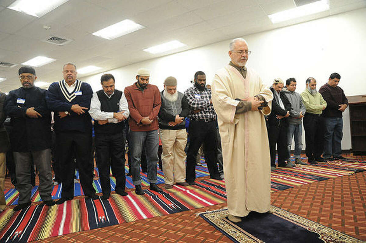 Azzeim Mahmoud, Imam for the al Madany Islamic Center in Norwalk leads a prayer Sunday. Elected officials and law enforcement met at the center to discuss how the community can work together to prevent discrimination and backlash against Muslims. Hour photo/Matthew Vinci
