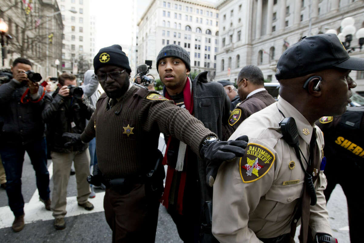 A demonstrator is arrested outside of the courthouse after a mistrial of Officer William Porter, one of six Baltimore city police officers charged in connection to the death of Freddie Gray, on Wednesday, Dec. 16, 2015, in Baltimore. (AP Photo/Jose Luis Magana)