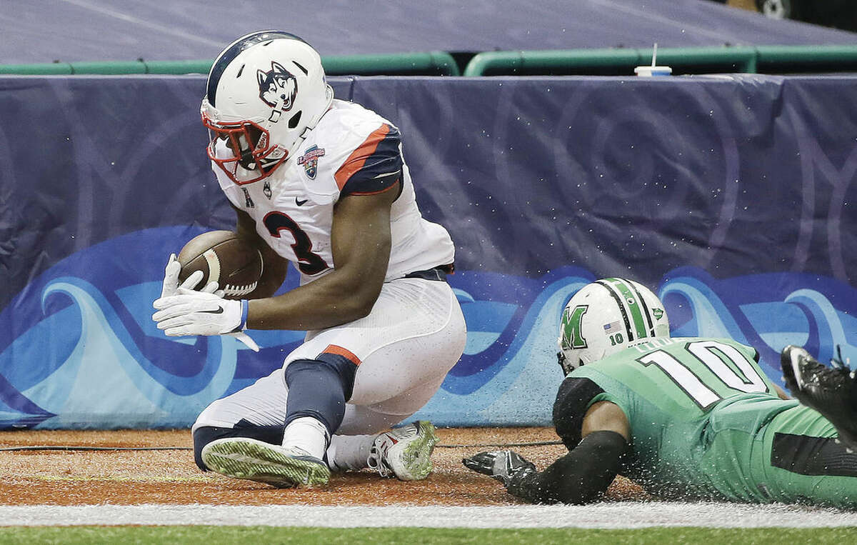 AP photo UConn running back Ron Johnson (3) runs into the end zone after getting past Marshall defensive back Corey Tindal (10) to score during the first quarter of Saturday's St. Petersburg Bowl in St. Petersburg, Fla. The Huskies lost to Marshall but they have many key players from the team returning next season.