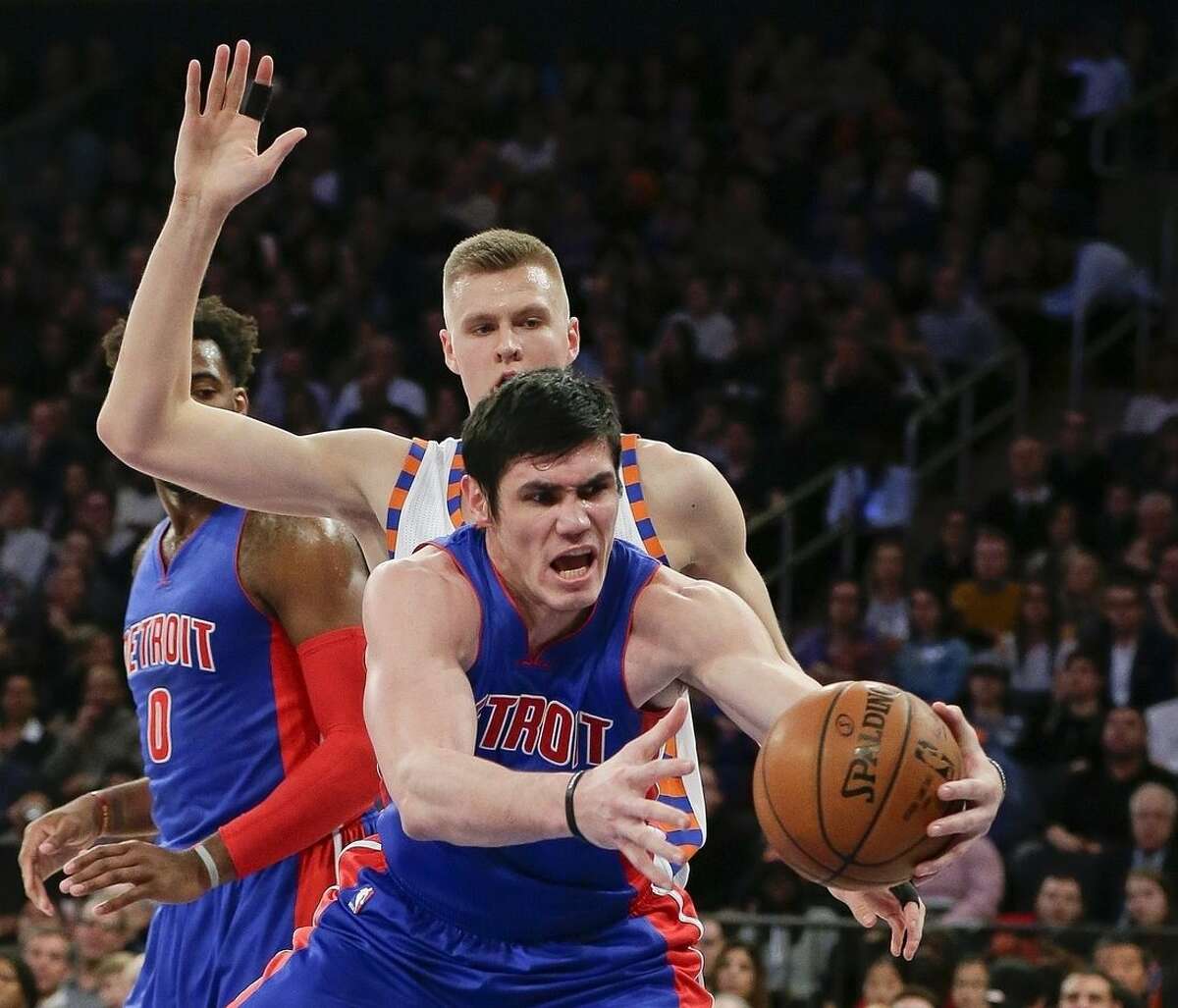 Detroit Pistons' Ersan Ilyasova, right, fights for the ball with New York Knicks' Kristaps Porzingis during the first half of an NBA basketball game Tuesday, Dec. 29, 2015, in New York. (AP Photo/Frank Franklin II)
