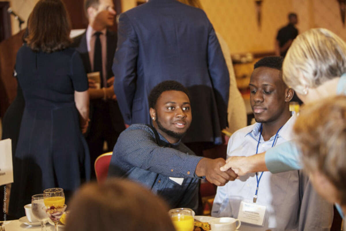 Contributed photo Marcus Stovall, Thrive by 25 Ambassador, shakes hands at a recent event.
