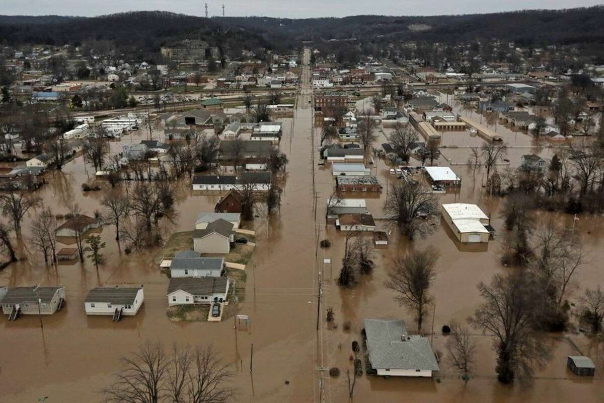 This photo shows a northern view of 1st Street where homes were flooded on Tuesday, Dec. 29, 2015, in Pacific, Mo. Torrential rains over the past several days pushed already swollen rivers and streams to virtually unheard-of heights in parts of Missouri and Illinois. (J.B. Forbes /St. Louis Post-Dispatch via AP) EDWARDSVILLE INTELLIGENCER OUT; THE ALTON TELEGRAPH OUT; MANDATORY CREDIT