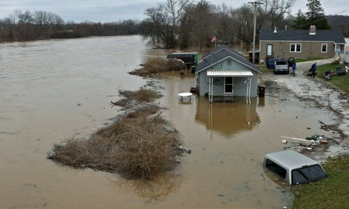 People move some of their belongings to higher ground on Tuesday, Dec. 29, 2015, as the Meramec River continues to rise next to the Gravois Road bridge in old town Fenton, Mo. Torrential rains over the past several days pushed already swollen rivers and streams to virtually unheard-of heights in parts of Missouri and Illinois. Record flooding was projected at some Mississippi River towns, and the Meramec River near St. Louis was expected to get to more than 3 feet above the previous record by late this week (J.B. Forbes /St. Louis Post-Dispatch via AP) EDWARDSVILLE INTELLIGENCER OUT; THE ALTON TELEGRAPH OUT; MANDATORY CREDIT