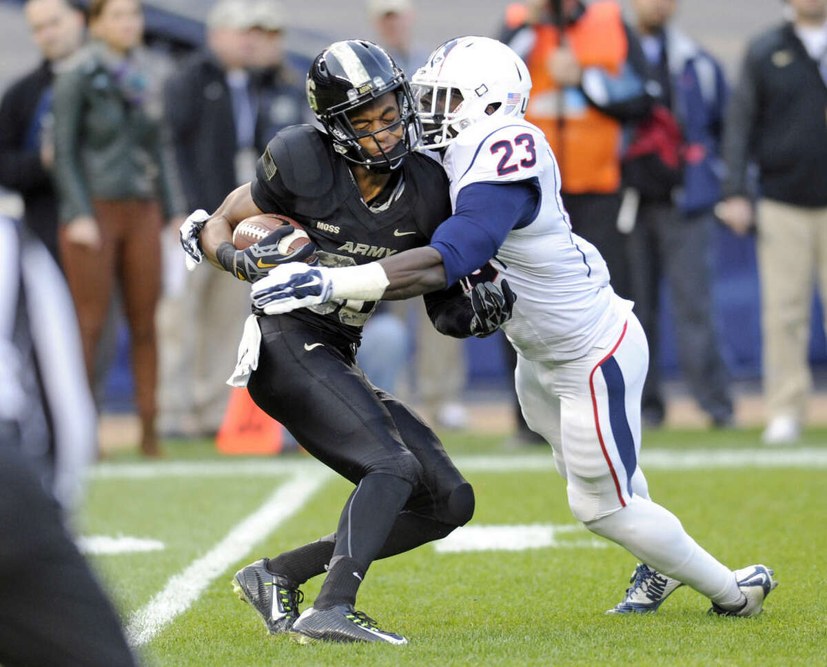 Connecticut safety Wilbert Lee, right, stops Army wide receiver Xavier Moss during the first half of an NCAA college football game Saturday, Nov. 8, 2014, at Yankee Stadium in New York. (AP Photo/Bill Kostroun)