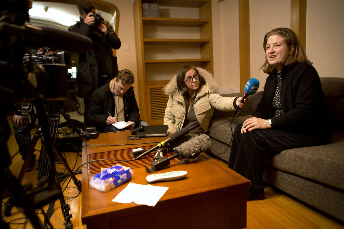 French journalist Ursula Gauthier, right, a reporter in China for the French news magazine L'Obs, speaks to the media in her apartment before leaving for the airport in Beijing, Thursday, Dec. 31, 2015. Gauthier is leaving China after being denied press credentials and facing heavy criticism from the Foreign Ministry and state media over her reporting, becoming be the first foreign journalist forced to leave China since 2012, when American Melissa Chan, then working for Al Jazeera in Beijing, was expelled. (AP Photo/Mark Schiefelbein)