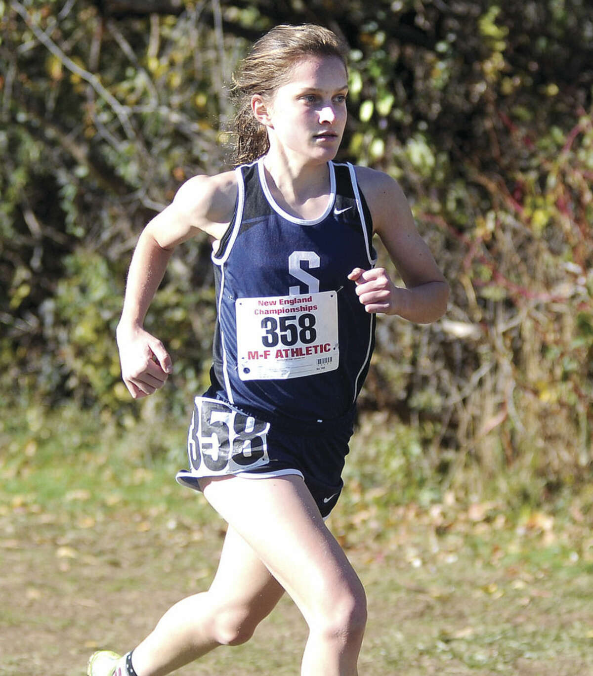 Hour photo/John Nash Staples High junior Hannah DeBalsi ran to her second straight New England cross country championship on Saturday at Wickham Park in Manchester.