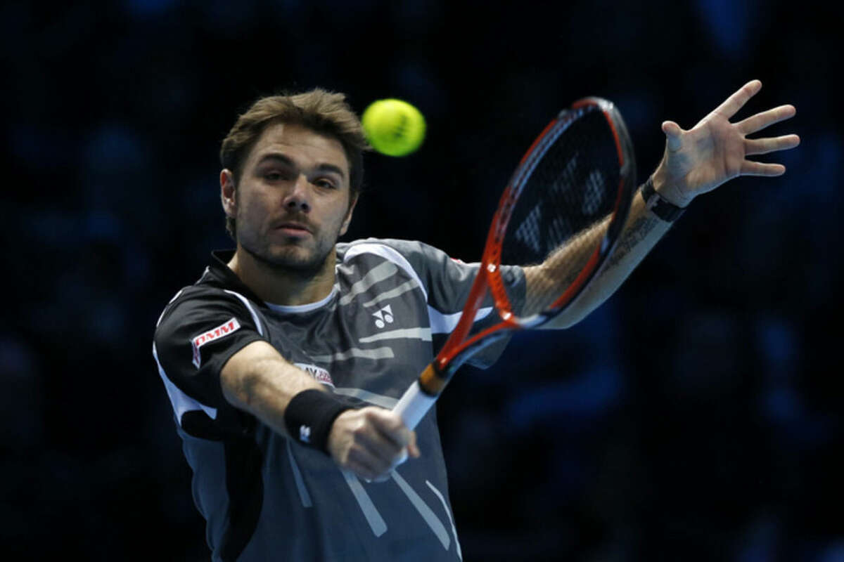 Switzerland’s Stanislas Wawrinka plays a return to Czech Republic’s Tomas Berdych during their singles ATP World Tour tennis finals match at the O2 arena in London, Monday, Nov. 10, 2014. (AP Photo/Alastair Grant)