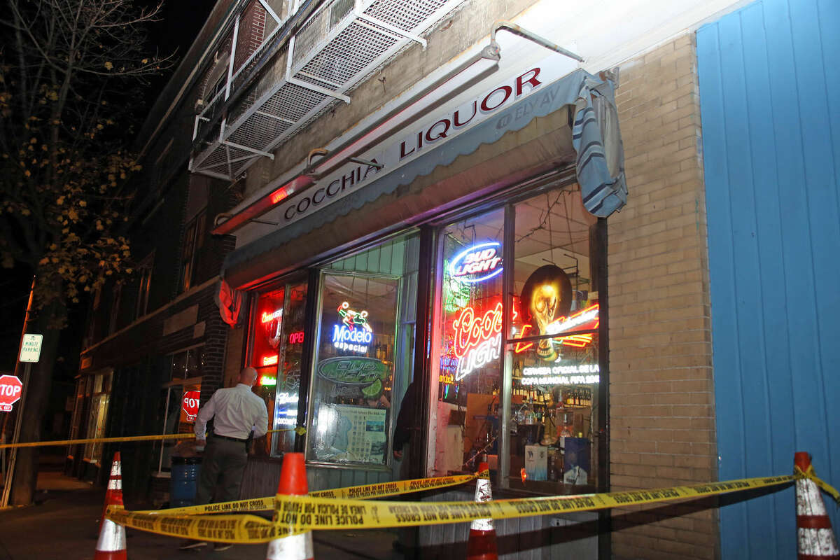 A detective checks out the scene of a stabbing at Cocchia Liquor on Ely Avenue Wednesday evening. Hour Photo / Danielle Calloway