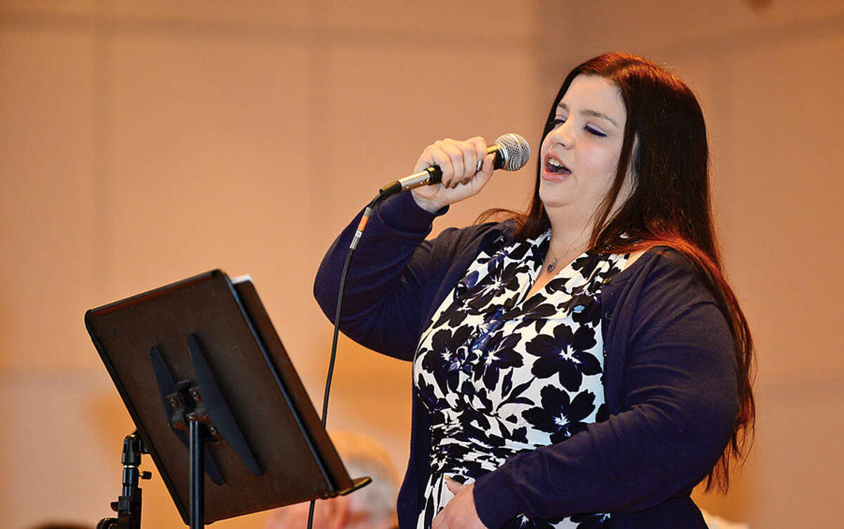 Hour photo / Erik Trautmann Alison Faye sings "The Battle Hym of the Republic" during the Norwalk Veteran's Day celebration at City Hall Tuesday morning.