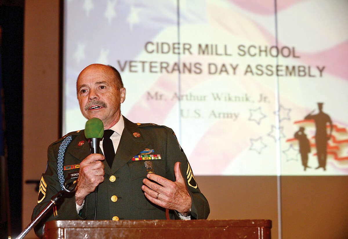 Hour photo / Erik Trautmann Viet Nam Army veteran Sgt. Arthur Wiknik gives his address during a Veteran's Day ceremony at Cider Mill Elementary School in Wilton Tuesday.