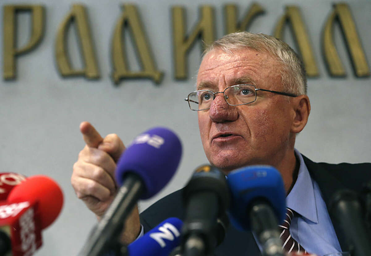 Serbian far-right leader Vojislav Seselj speaks during a press conference in Belgrade, Serbia, Thursday, Nov. 13, 2014. Judges at the U.N. war crimes tribunal released Seselj, accused of recruiting notorious paramilitary forces during the bloody Balkan wars, to arrive home to a boisterous welcome Wednesday after his provisional release due to ill health. (AP Photo/Darko Vojinovic)