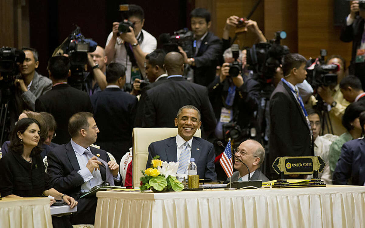 U.S. President Barack Obama, center, smiles as he speaks with Daniel R. Russel, U.S. Assistant Secretary of State for the Bureau of East Asian and Pacific Affairs, right, as he attends an East Asia Summit Plenary at the Myanmar International Convention Center, Thursday, Nov. 13, 2014 in Naypyitaw, Myanmar. (AP Photo/Pablo Martinez Monsivais)