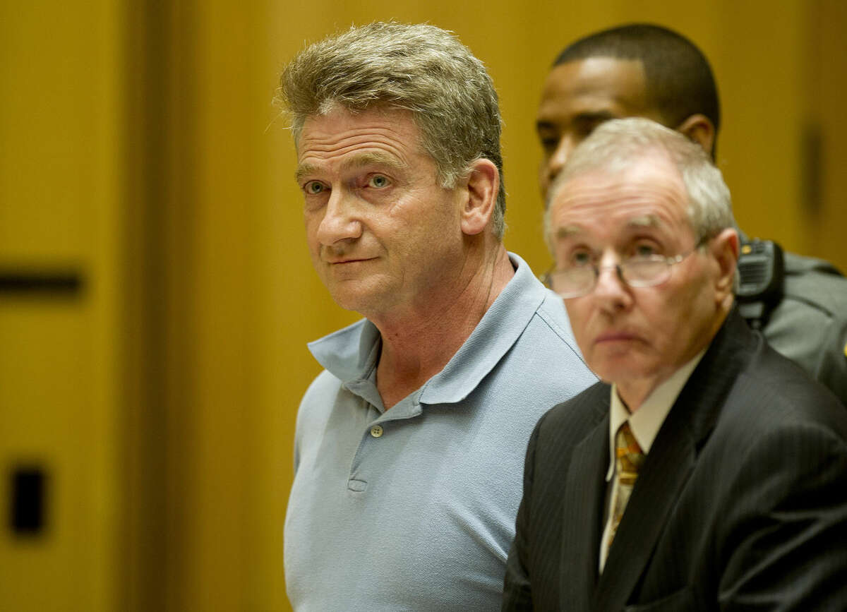 Lindsay Perry/Stamford Advocate Robert Aillery, owner of Stright Sewage Disposal Co., stands with his attorney, Fred Ury, as he is arraigned in State Superior Court in Stamford, Conn., on Thursday, November 13, 2014, on charges that he allegedly illegally dumped 7 million gallons of raw sewage in a sewer pipe in the garage of his Knickerbocker Avenue home.