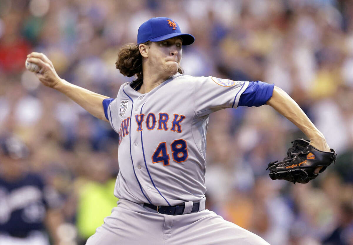 FILE - This is a July 27, 2014, file photo showing New York Mets starting pitcher Jacob deGrom throwing against the Milwaukee Brewers during the sixth inning of a baseball game in Milwaukee. DeGrom has been voted NL Rookie of the Year the Baseball Writers' Association of America announced Monday, Nov. 10, 2014. (AP Photo/Jeffrey Phelps, File)
