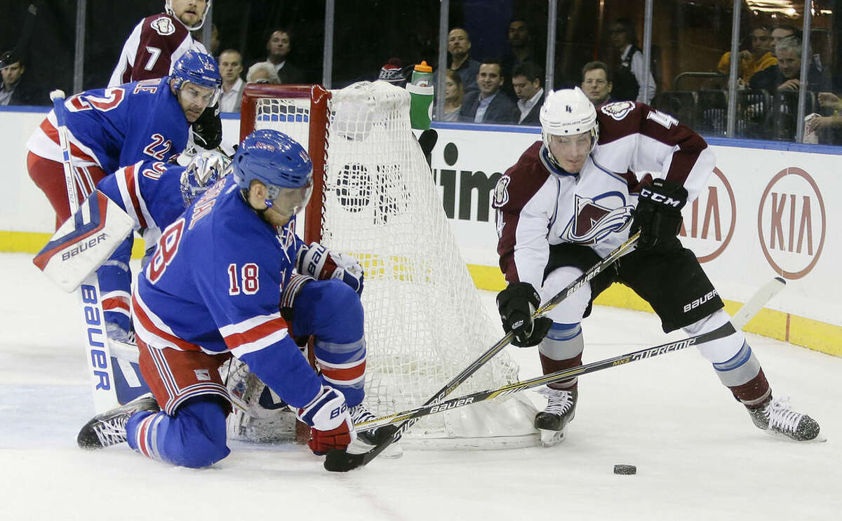 Colorado Avalanche's Tyson Barrie (4) is defended by New York Rangers' Marc Staal during the first period of an NHL hockey game Thursday, Nov. 13, 2014, in New York. (AP Photo/Frank Franklin II)
