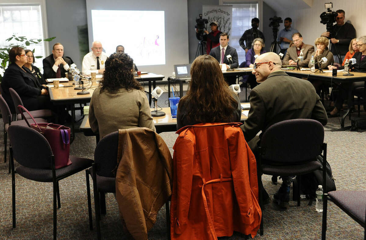 Jeremy Richman, right, and his wife Jennifer Hensel, center, parents of Sandy Hook Elementary school shooting victim Avielle Richman, and Nelba Marquez-Greene, left, mother of victim Ana Marquez-Greene address the Sandy Hook Advisory Commission, Friday, Nov. 14, 2014, in Newtown, Conn. The parents made presentations on ways to better address mental health, school safety and gun violence prevention. (AP Photo/Jessica Hill)