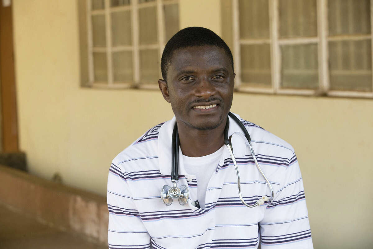 In this April 2014 photo provided by the United Methodist News Service, Dr. Martin Salia poses for a photo at the United Methodist Church's Kissy Hospital outside Freetown, Sierra Leone. Salia has tested positive for Ebola and will be flown, on Saturday, Nov. 15, 2014, to the Nebraska Medical Center, in Omaha, Neb., for treatment. (AP Photo/United Methodist News Service, Mike DuBose) MANDATORY CREDIT
