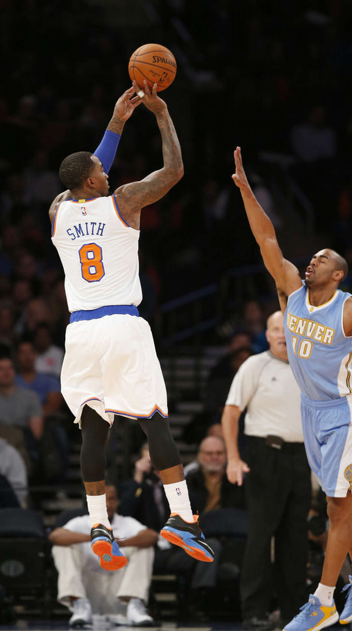 New York Knicks guard J.R. Smith (8) shoots over the defense of Denver Nuggets guard Arron Afflalo (10) in the first half of an NBA basketball game in New York, Sunday, Nov. 16, 2014. (AP Photo/Kathy Willens)