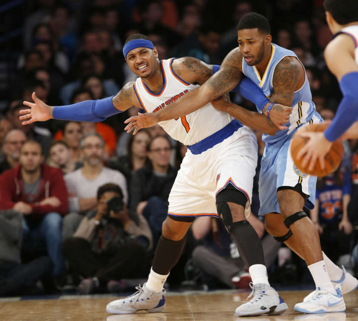 New York Knicks forward Carmelo Anthony (7) calls for the ball from Knicks guard Pablo Prigioni, right, as Denver Nuggets forward Alonzo Gee, center, defends in the first half of an NBA basketball game in New York, Sunday, Nov. 16, 2014. (AP Photo/Kathy Willens)