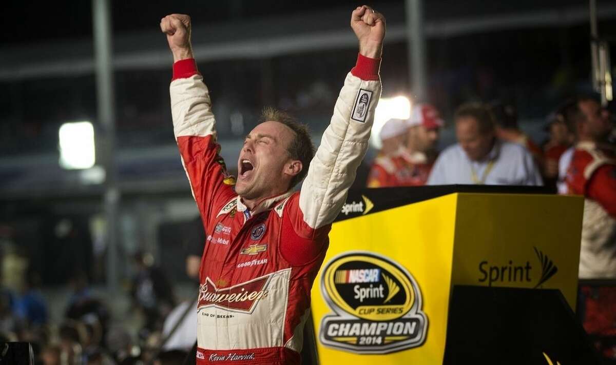 Kevin Harvick celebrates winning the NASCAR Sprint Cup championship series auto race, Sunday, Nov. 16,2014 in Homestead, Fla. (AP Photo/J Pat Carter)
