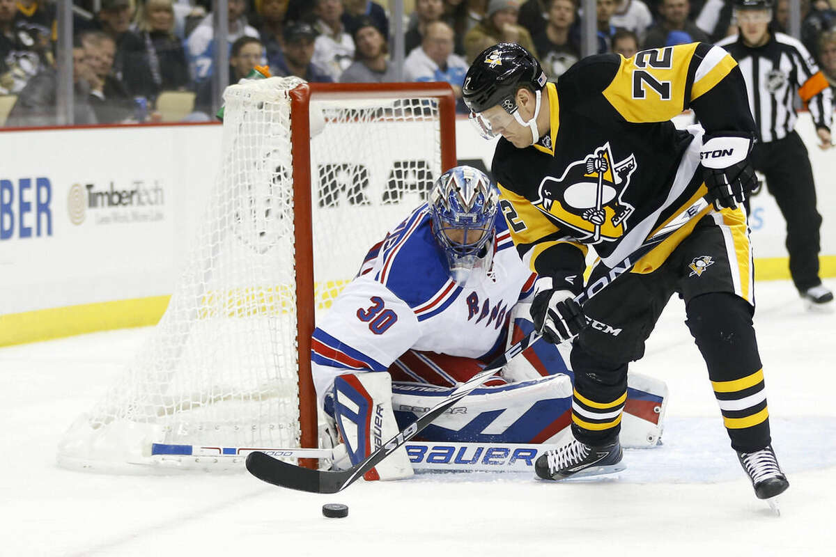 New York Rangers goalie Henrik Lundqvist (30) stops a shot by Pittsburgh Penguins' Patric Hornqvist (72) in the second period of an NHL hockey game, Saturday, Nov. 15, 2014, in Pittsburgh. (AP Photo/Keith Srakocic)