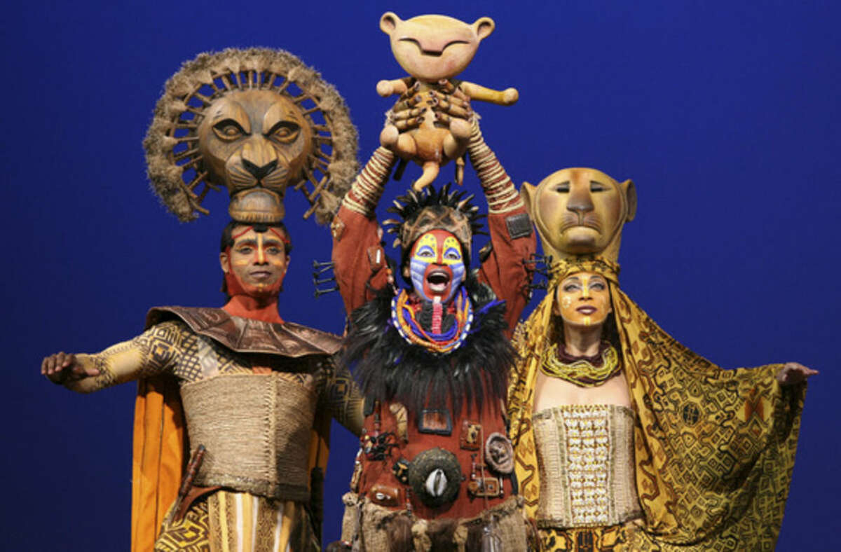 FILE - This file photo released by the Disney Theatrical Group shows, from left, Nathaniel Stampley as Mufasa, Tshidi Manye as Rafiki, and Jean Michelle Grier as Sarabi, in Disney's "The Lion King." Disney Theatrical Productions is letting ticketholders to its Broadway shows _ “Aladdin” and “The Lion King” _ the chance to switch the dates they see the musicals for any reason as long as it’s done two hours before the performance. (AP Photo/Disney Theatrical Group, Joan Marcus, File)
