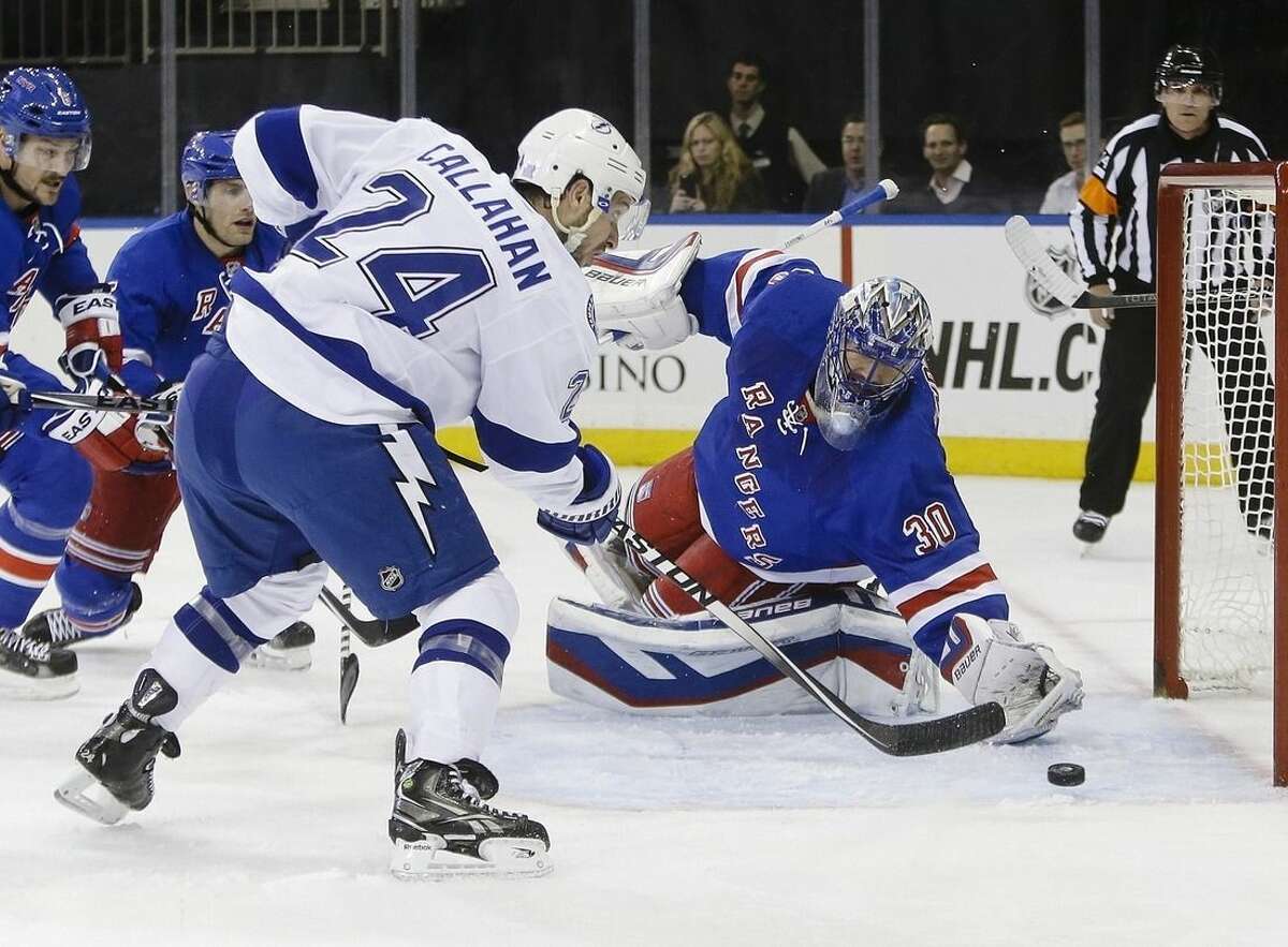 Tampa Bay Lightning's Ryan Callahan (24) shoots the puck past New York Rangers' Henrik Lundqvist (30), of Sweden, during the first period of an NHL hockey game Monday, Nov. 17, 2014, in New York. (AP Photo/Frank Franklin II)