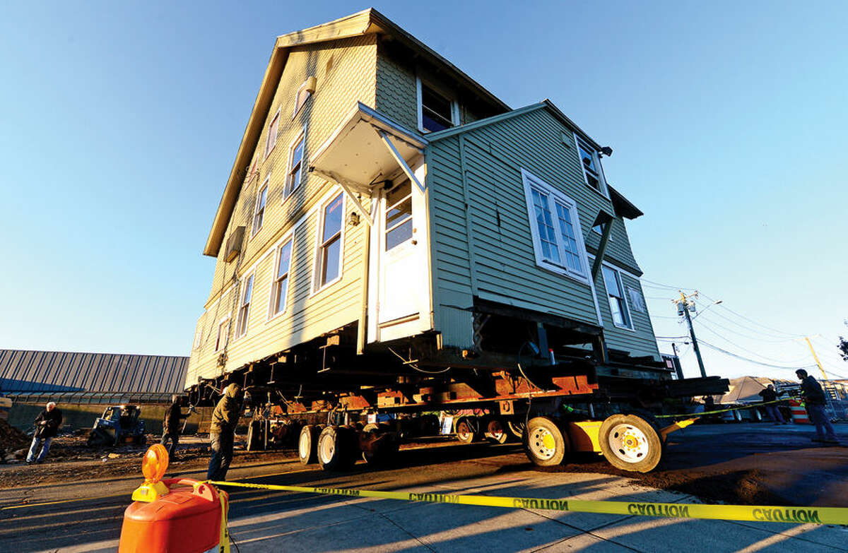 Hour photo / Erik Trautmann Westport's historic Kemper Gunn house is relocated from 35 Church St across the street to the Baldwin parking lot early Tuesday morning.