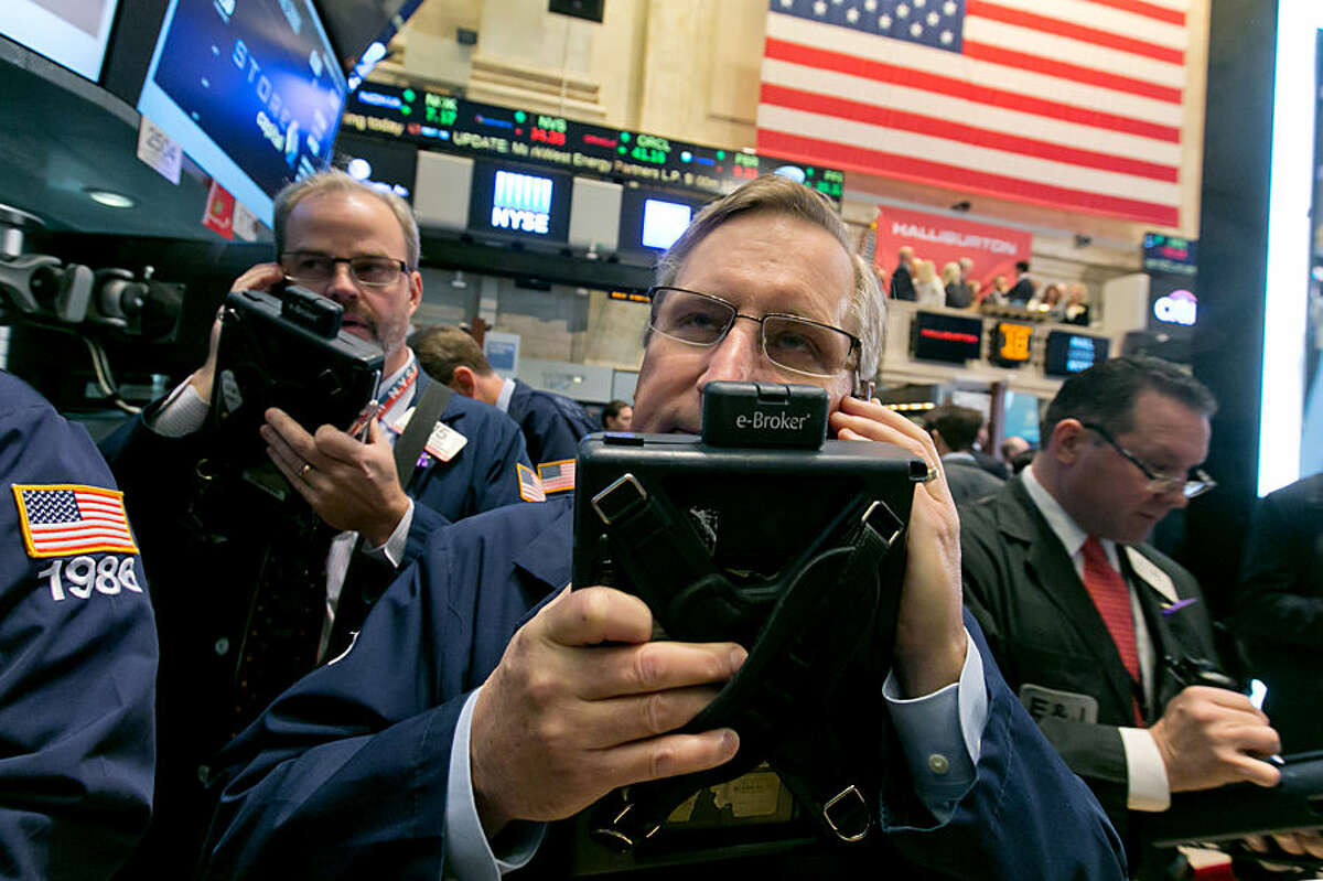 Traders David O'Day, left, and Christopher Fuchs, work on the floor of the New York Stock Exchange, Tuesday, Nov. 18, 2014. Major U.S. stocks opened higher on Tuesday, a day after the Standard & Poor's 500 index set its second record-high close in two days. (AP Photo/Richard Drew)