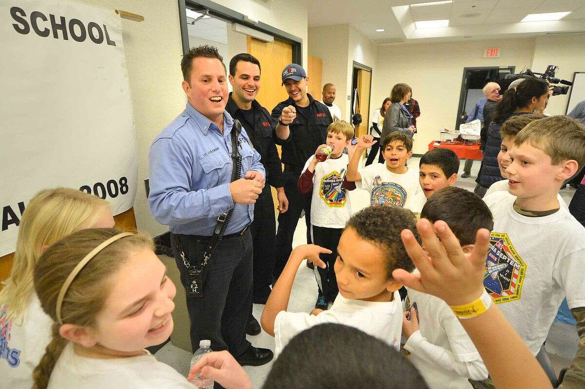 Hour Photo/Alex von Kleydorff Lt. Lenny Coleman and Firefighters Nick Lipeika and Anthony Papacoda from Station 2, talk about the program with some of the Columbus Magnet School Young Astrnauts