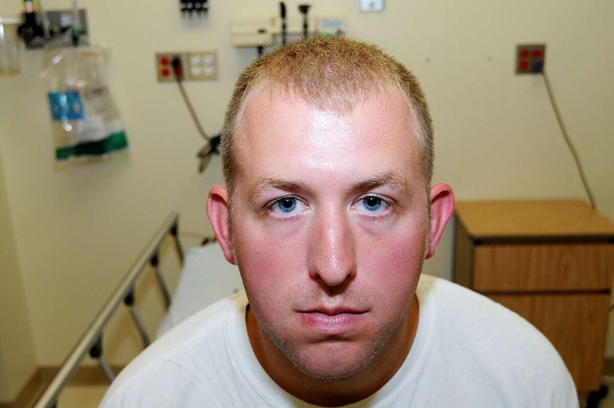 FILE- This undated file photo released by the St. Louis County Prosecuting Attorney's office on Monday, Nov. 24, 2014, shows Ferguson police officer Darren Wilson during his medical examination after he fatally shot Michael Brown, in Ferguson, Mo. The white police officer who killed Michael Brown has resigned from the Ferguson Police Department, nearly four months after the confrontation that fueled protests in the St. Louis suburb and across the U.S. Wilson has been on administrative leave since the Aug. 9 shooting. His resignation was announced Saturday, Nov. 29, 2014, by one of his attorneys, Neil Bruntrager. Bruntrager said the resignation is effective immediately. (AP Photo/St. Louis County Prosecuting Attorney's Office, File)