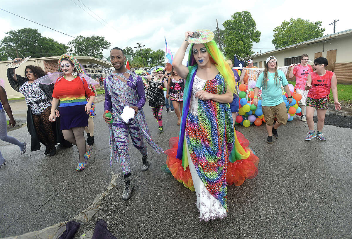 Parade goers brave the rain as they march toward Crockett Street during the opening parade of Saturday's Pride Festival. Spirits were high as marchers trekked half a mile in a steady downpour, celebrating with dancing and bursts of confetti upon reaching the venue downtown. Photo taken Saturday, June 11, 2016 Kim Brent/The Enterprise