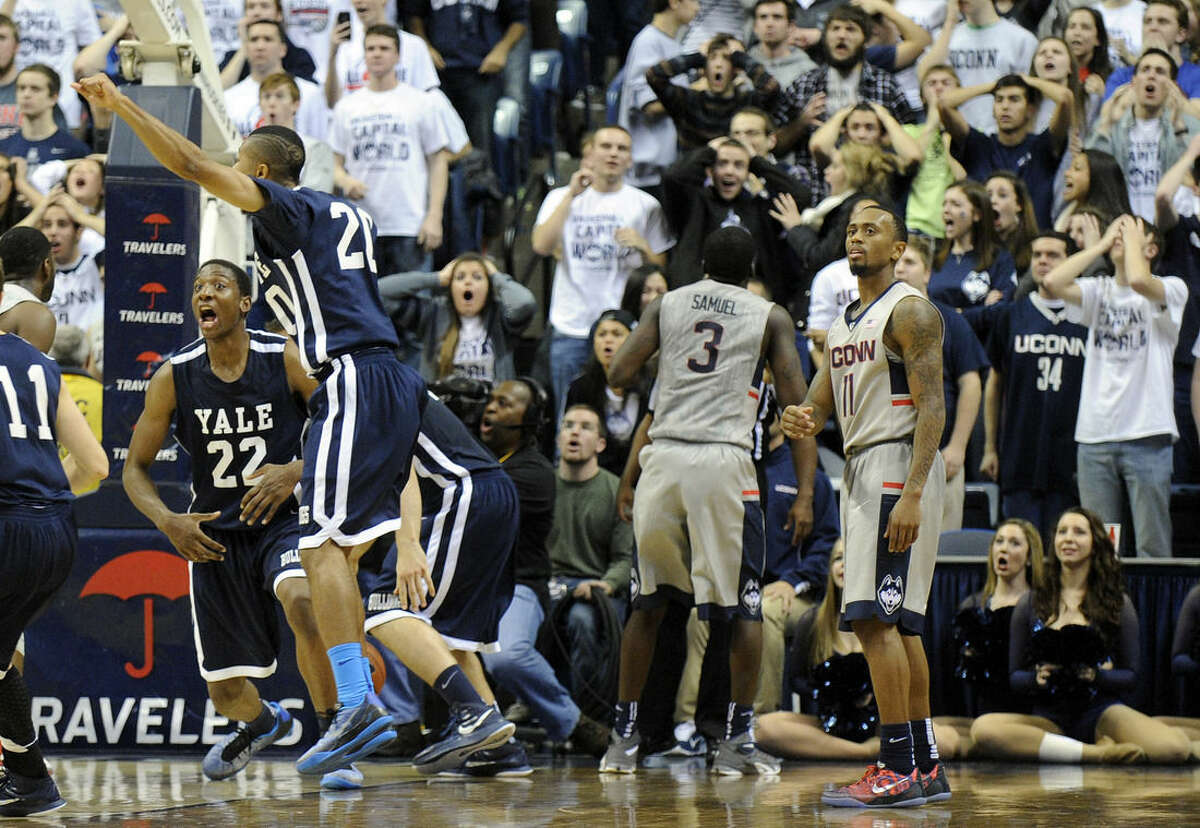 Connecticut's Ryan Boatright (11), players and fans react to Yale's game winning three point shot during the second half of Yale's 45-44 upset victory in an NCAA college basketball game in Storrs, Conn., on Sunday, Dec. 5, 2014. (AP Photo/Fred Beckham)