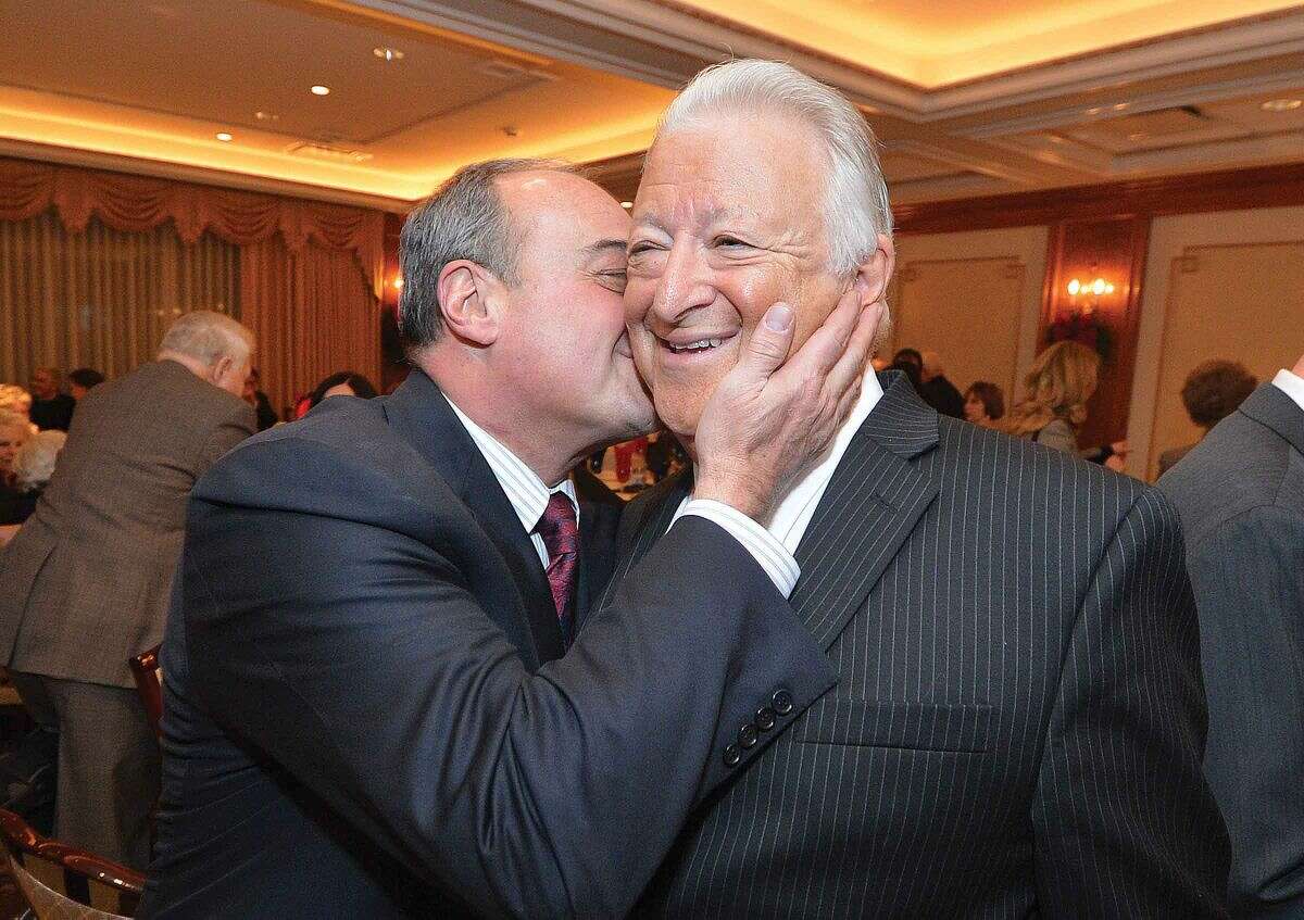 Hour Photo/Alex von Kleydorff Former Norwalk Mayor Richard Moccia gets a hug and a kiss from friend and House Minority Leader Larry Cafero during a tribute evening in honor of Dick Moccia at The Norwalk Inn and Conference Center