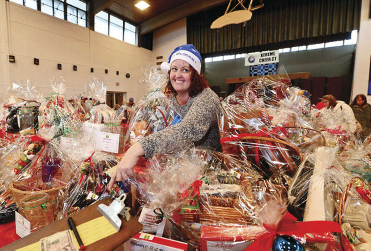 Hour photo / Erik Trautmann Shelly Grace sells tickets for the silent auction during the St. Ladislaus annual Christmas fair Saturday.