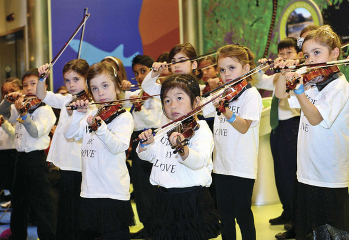 Hour photo/Erik Trautmann As part of the December music series at the Maritime Aquarium, students of the Talent Education Suzuki School (TESS) Mixed Ensemble perform classical selections, including pieces by Bach, Giuliani and Paganini.